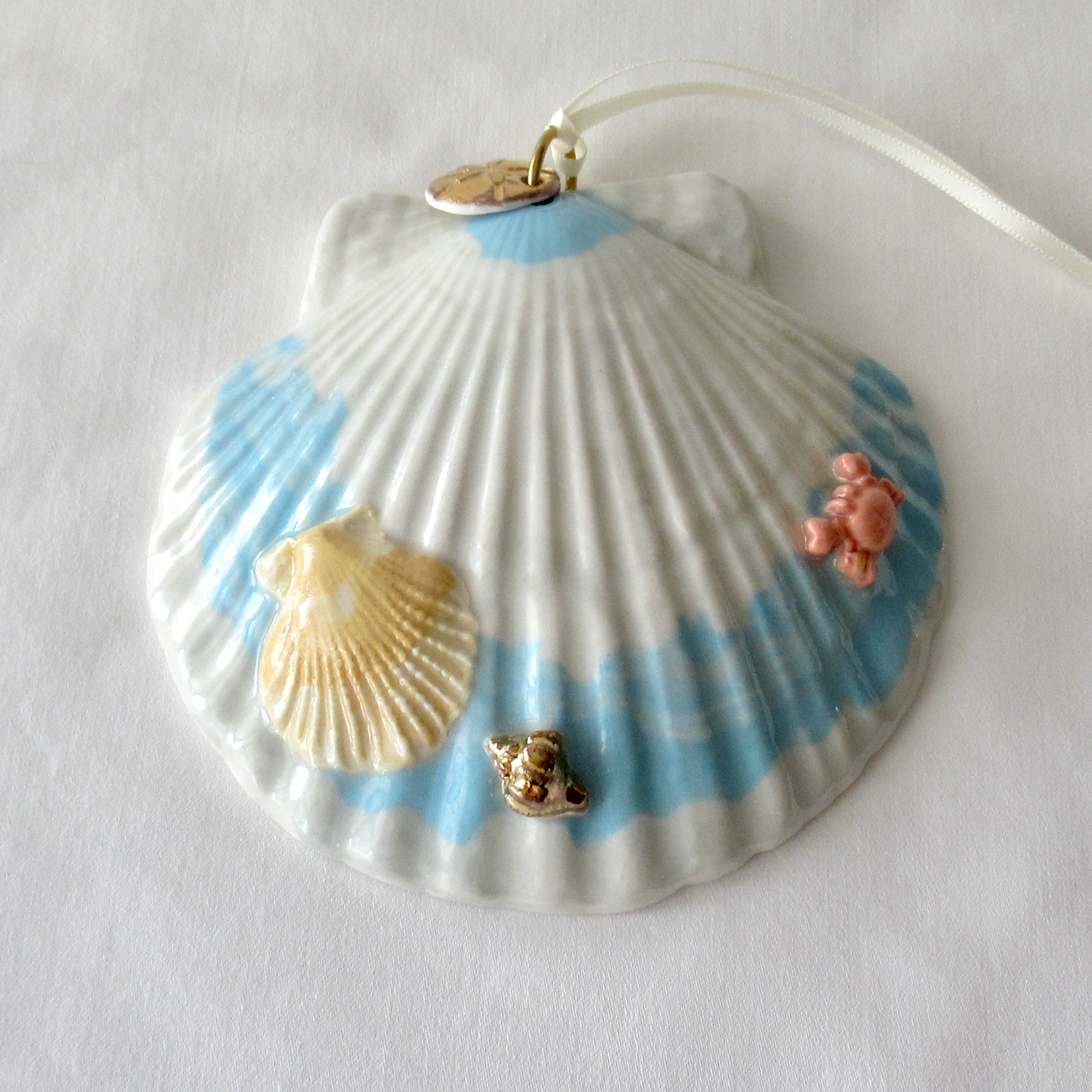 Handmade Seashell Blue and White Colored Porcelain Hanging Ornament. Ceramic Pottery.