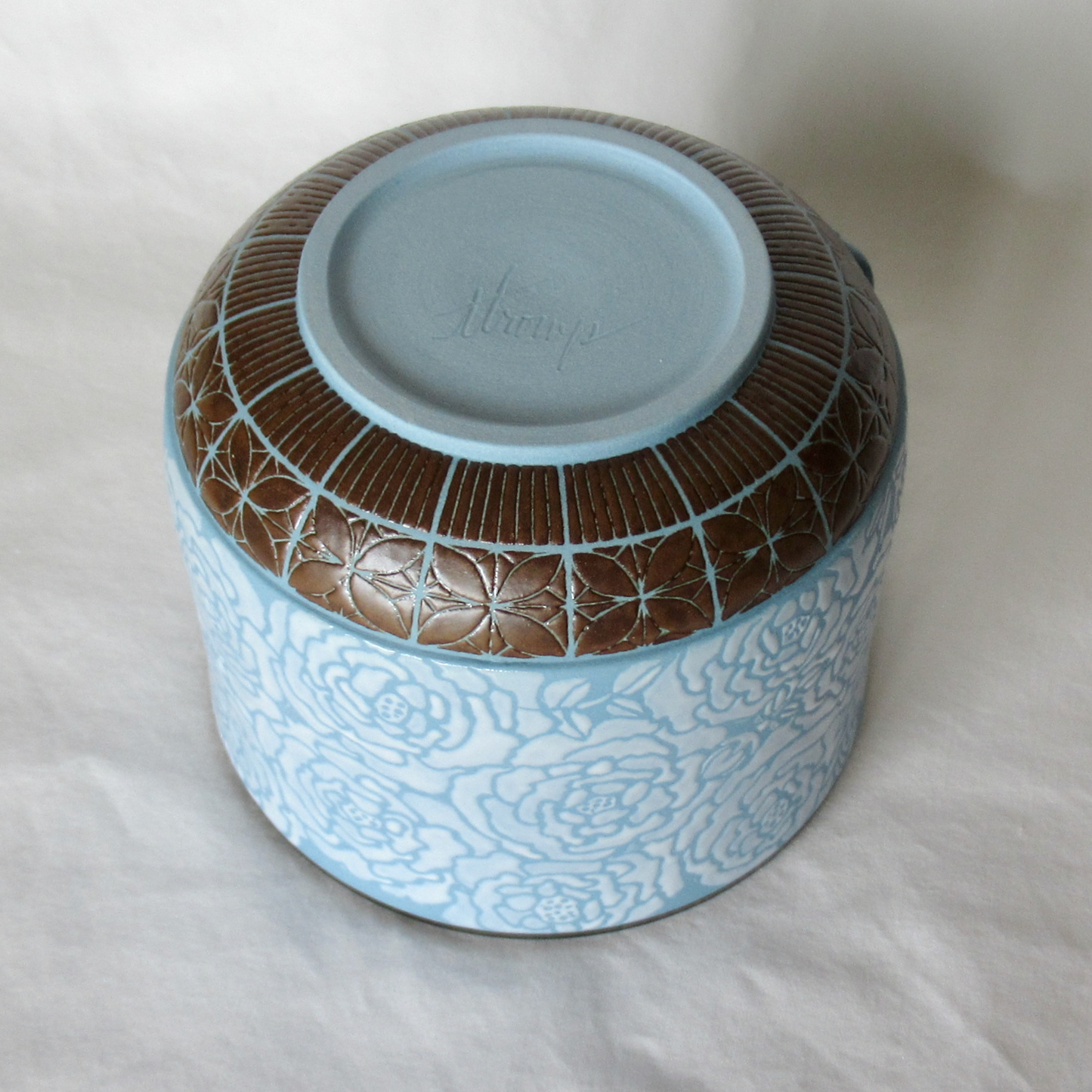A Rouleau Loops, Buttons and White Roses on a Blue Porcelain Bowl