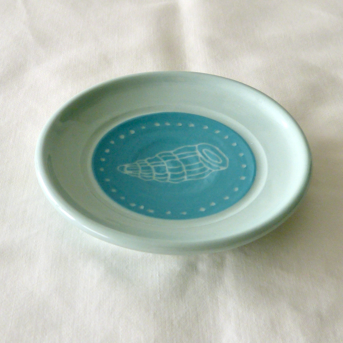 A Blue Porcelain Wheel- thrown, Conch Shell Sgraffito Shallow Bowl.
