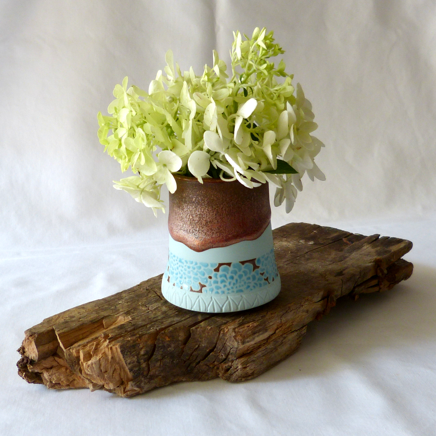 A Blue Turquoise Dahlia Bud Vase with Copper Float Rim