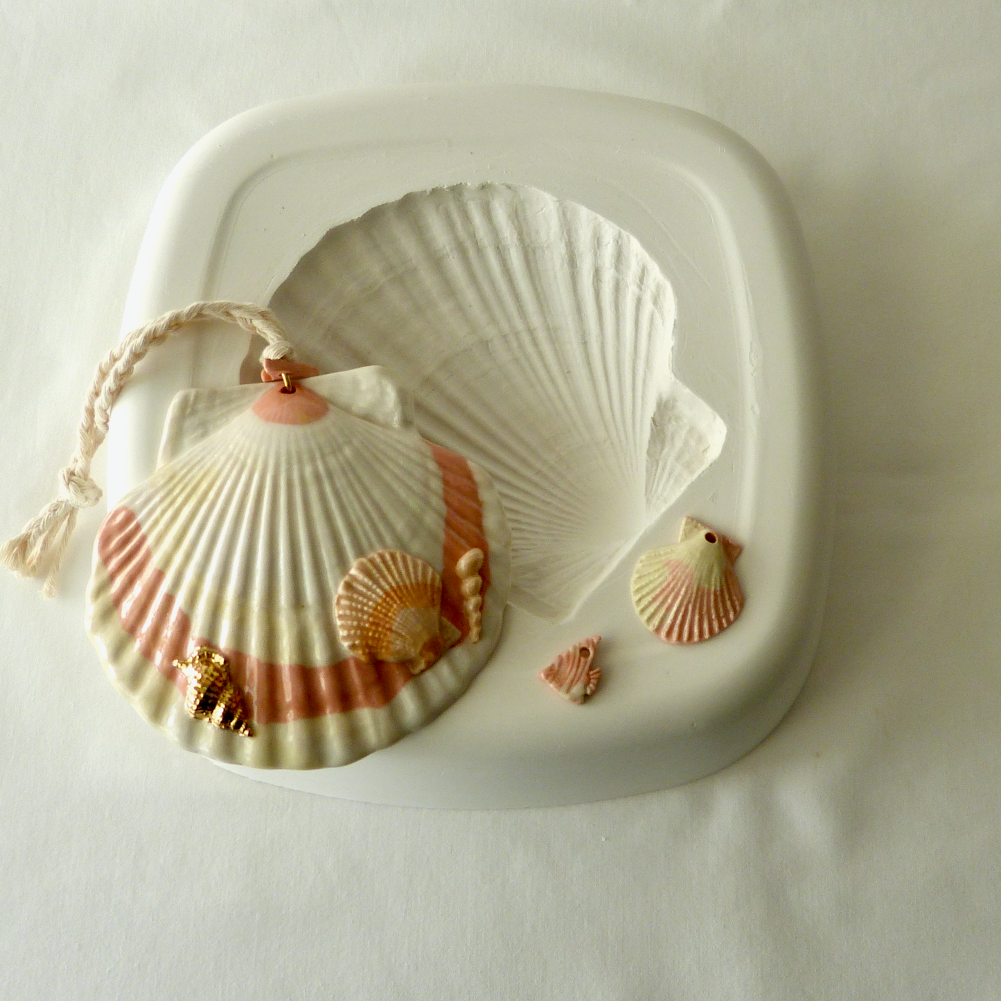 A Handmade Agateware Seashell, Peach Colored Porcelain Hanging Ornament. Ceramic Pottery.