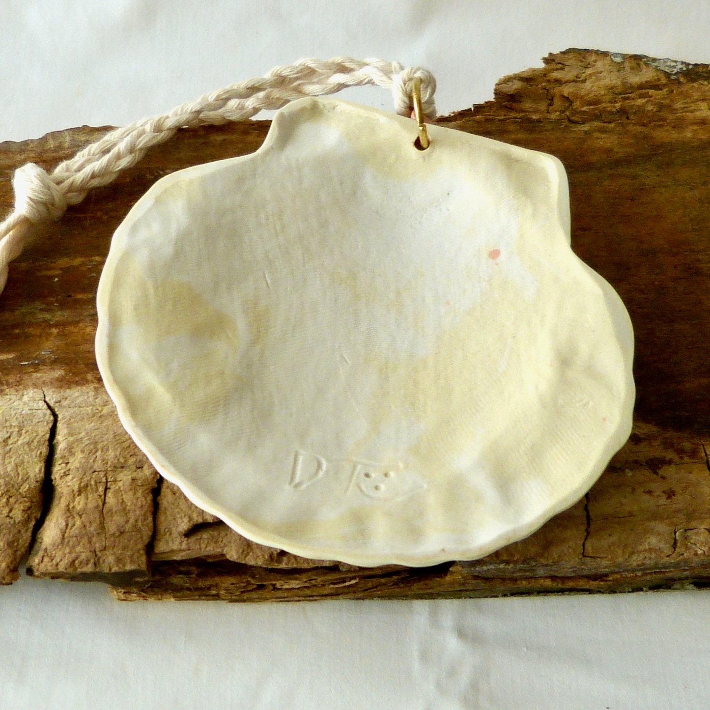 A Handmade Agateware Seashell, Peach Colored Porcelain Hanging Ornament. Ceramic Pottery.