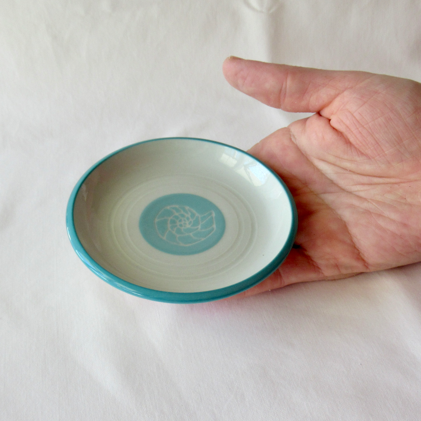 A Small Wheel-thrown Sgraffito Conch Shell Plate