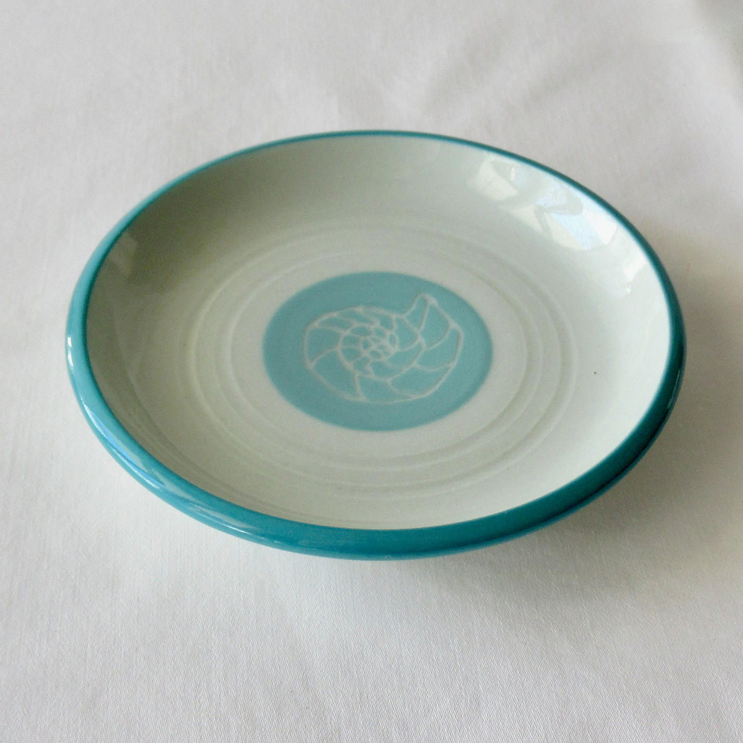 A Small Wheel-thrown Sgraffito Conch Shell Plate