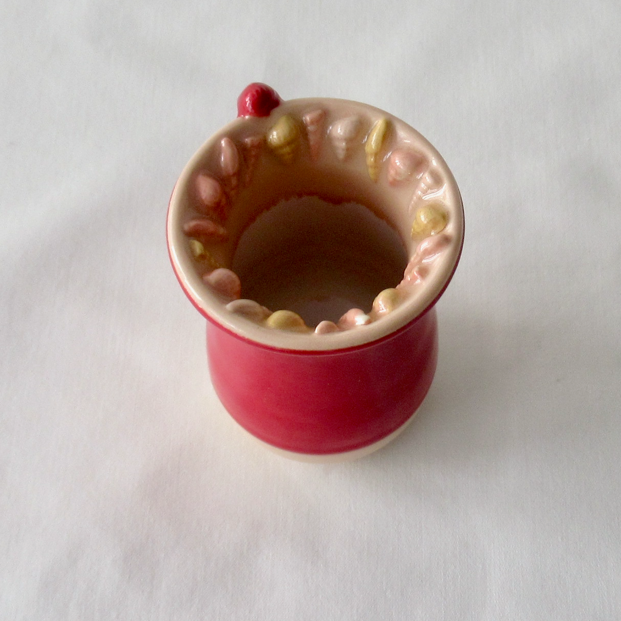 Handmade Seashell Bud Vase. Dark Red Celadon Glaze with Sand Dollar Charms.